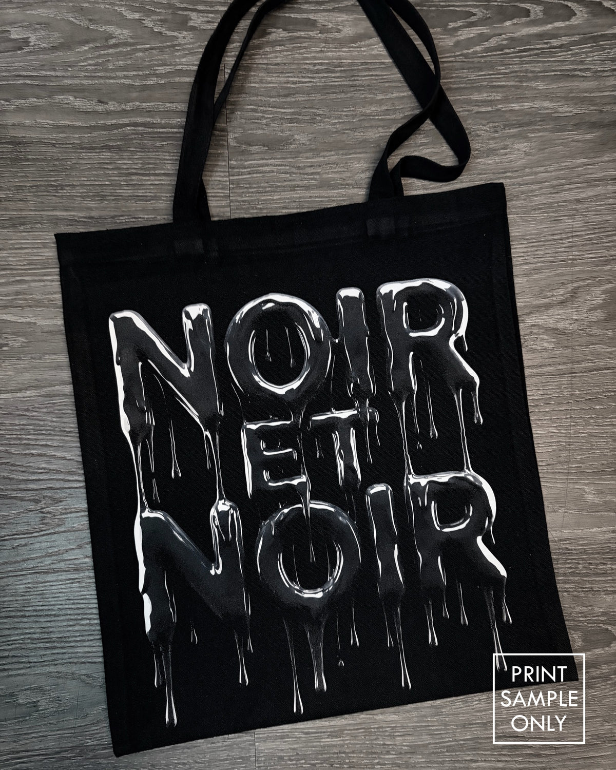 Sample print on a black canvas tote bag: dripping lettering (print sample only)