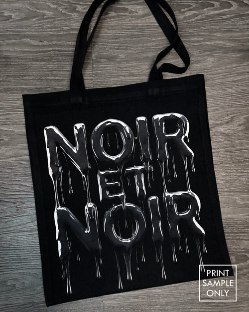 Sample print on a black canvas tote bag: dripping lettering (print sample only)
