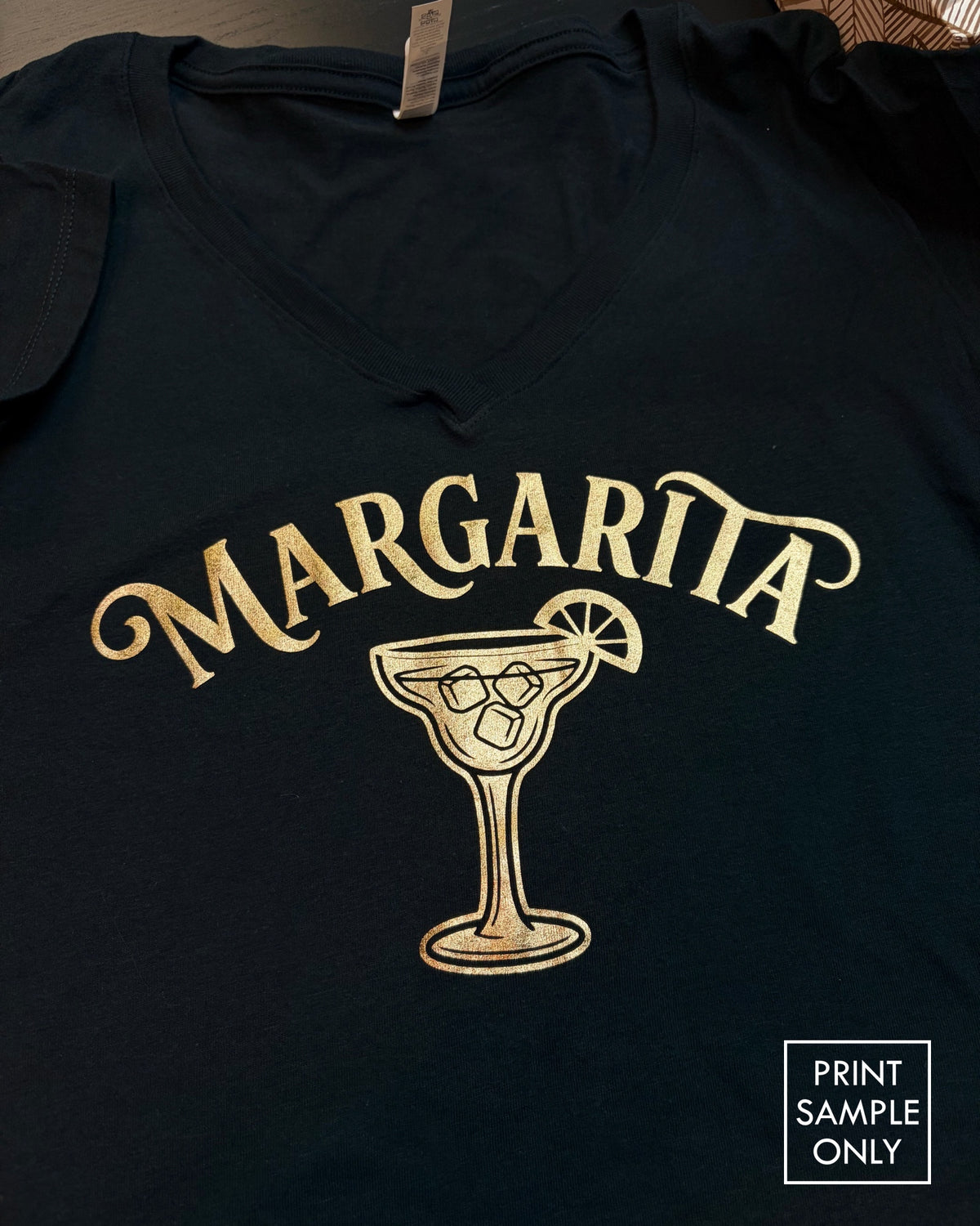 Sample print on a black V-neck t-shirt: gold margarita glass (print sample only)