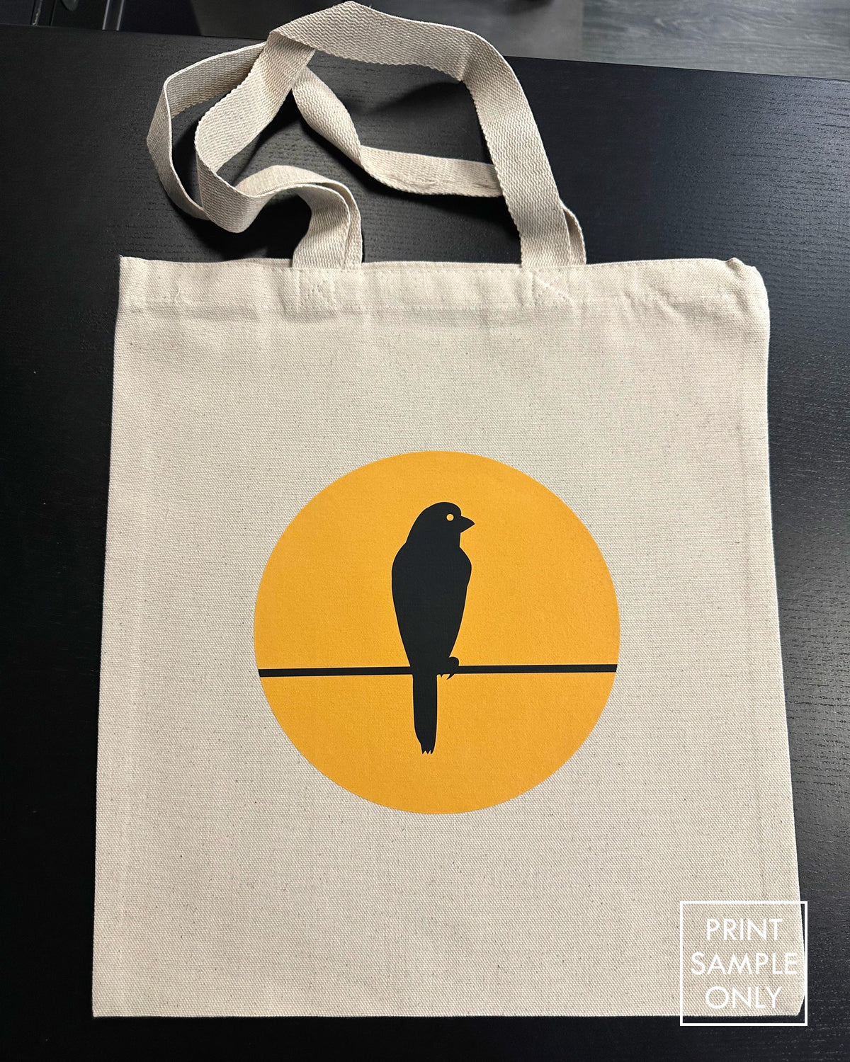 Sample print on a natural canvas tote bag: bird on a wire (print sample only)